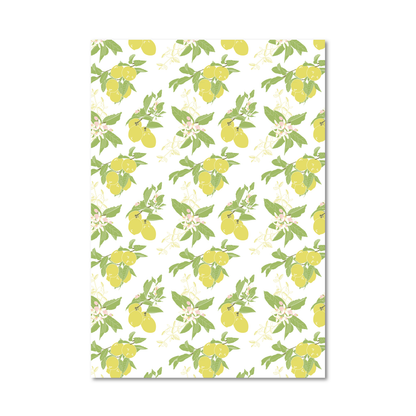 Gift wrap sheet featuring a repeating pattern of yellow lemons, green leaves, and small pale flowers on a white background, shown against a light gray studio backdrop.