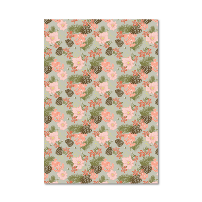 Gift wrap sheet with a repeating floral and pinecone pattern on a pale sage green background, shown against a plain white studio backdrop.