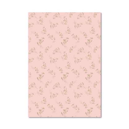 Gift wrap sheet with a light pink background and a repeating pattern of small green branch and dot illustrations, shown against a white background.