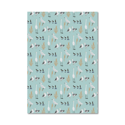 Patterned gift wrap sheet with a light blue background and a tossed print of illustrated sea birds like egrets and sea gulls