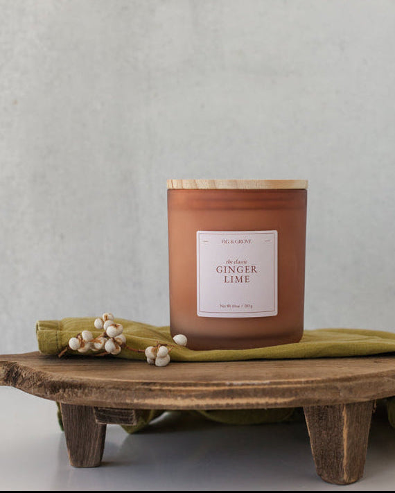 Ginger Lime candle by Fig &amp; Grove, featuring a minimalist label and natural soy wax, with calming scents of ginger and lime essential oils.