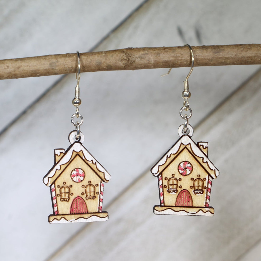Hand-painted wooden gingerbread house dangle earrings with festive Christmas design and hypoallergenic sterling silver hooks, lightweight holiday jewelry for cookie lovers and cozy winter style by Cate’s Concepts
