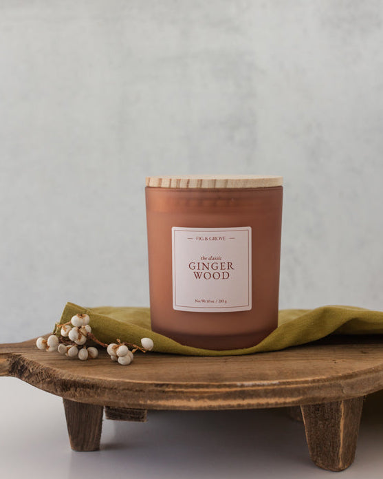  Gingerwood soy candle with warm ginger and palo santo in 10 oz jar.