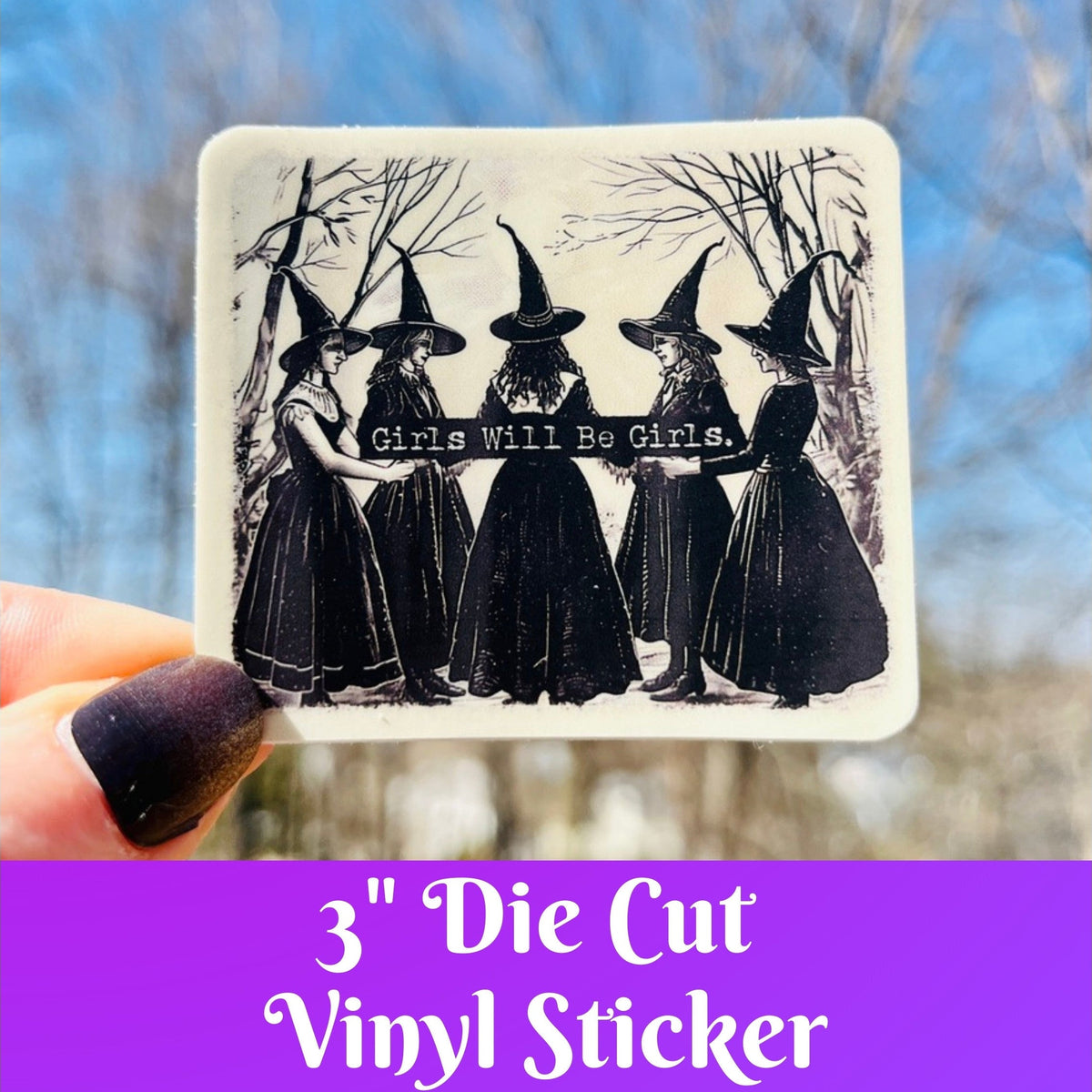A hand holds a square die-cut vinyl sticker featuring a black-and-white illustration of five witches in pointed hats with the text &
