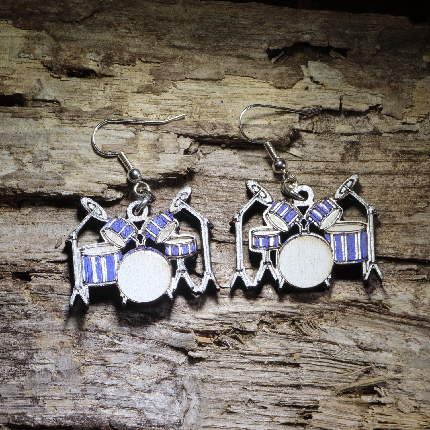 Hand-painted drum set wooden dangle earrings featuring a blue and silver drum kit with cymbals and detailed percussion styling. Lightweight music jewelry perfect for drummers, percussionists, band directors, music teachers, students, and drummer gifts.