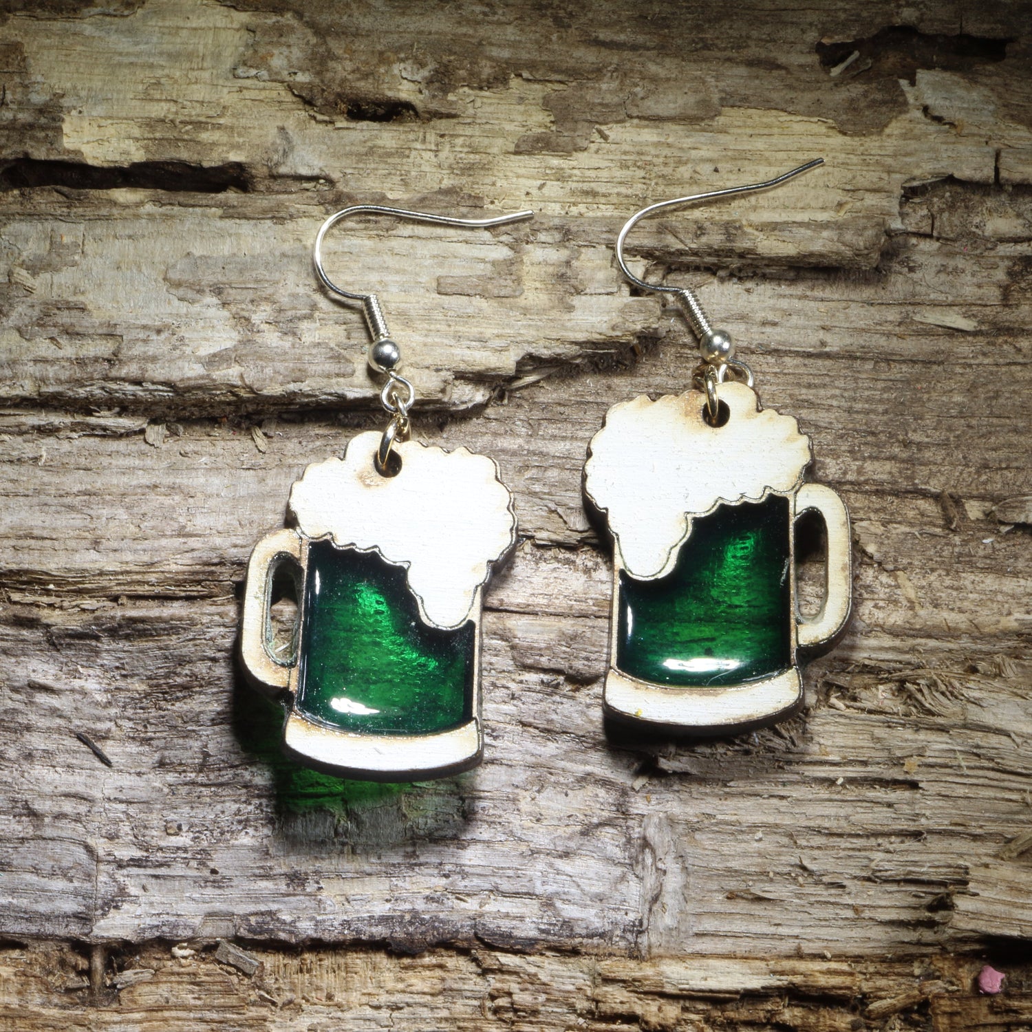 Hand-painted green beer mug wooden dangle earrings featuring frothy white foam and a rich green resin inlay. Lightweight beer lover jewelry perfect for St. Patrick’s Day celebrations, pub outings, festivals, and fun Irish-themed gifts.