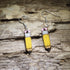 Hand-painted pencil wooden dangle earrings featuring a classic yellow pencil design with pink erasers and sharpened tips. Lightweight teacher earrings perfect for educators, back-to-school outfits, art teachers, writers, and fun classroom jewelry.