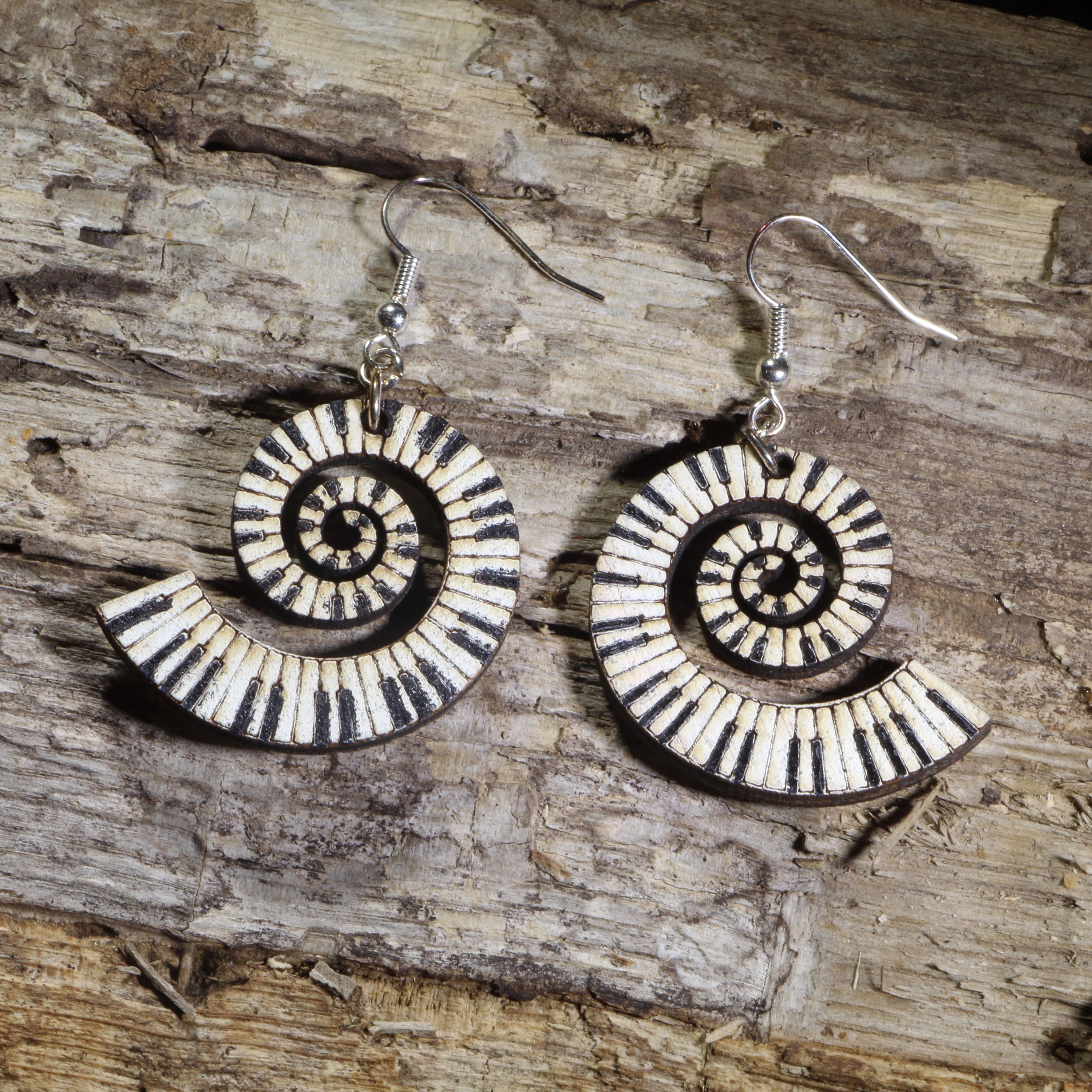 Hand-painted spiral piano keyboard wooden dangle earrings on hypoallergenic .925 sterling silver hooks. Lightweight music jewelry featuring a swirling piano keyboard design, perfect for pianists, piano teachers, musicians, music students, and keyboard lovers.