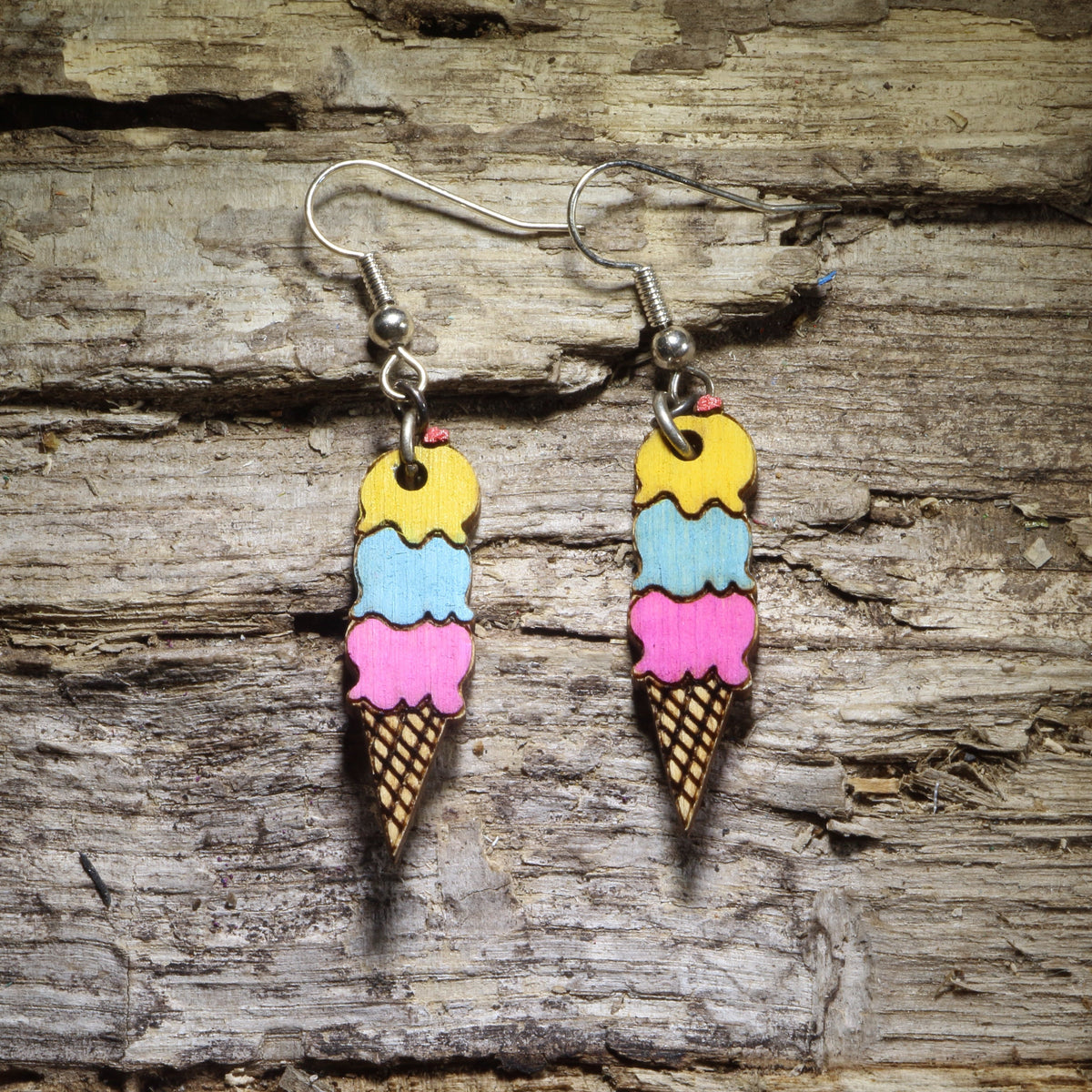Hand-painted triple scoop ice cream cone wooden dangle earrings with yellow, blue, and pink scoops, colorful dessert jewelry for ice cream lovers