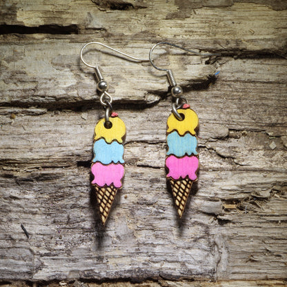 Hand-painted triple scoop ice cream cone wooden dangle earrings with yellow, blue, and pink scoops, colorful dessert jewelry for ice cream lovers