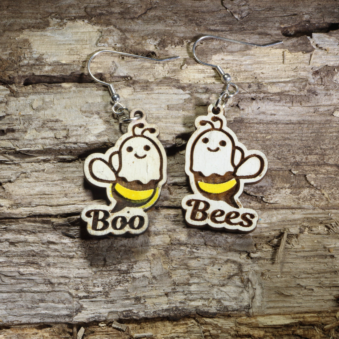 Hand-painted wooden "Boo Bees" dangle earrings featuring adorable smiling ghost bees with yellow stripes and the playful "Boo Bees" pun on hypoallergenic .925 sterling silver hooks. Lightweight Halloween jewelry for bee lovers, ghost fans, fall festivals, spooky season, and anyone who enjoys cute Halloween accessories.