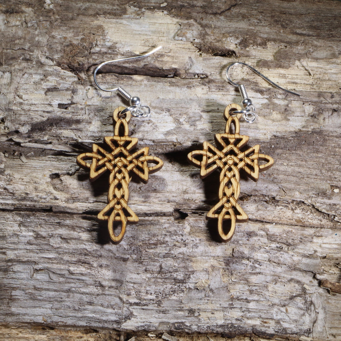 Hand-painted wooden Celtic cross dangle earrings featuring an intricate Celtic knot design on hypoallergenic .925 sterling silver hooks. Lightweight Christian and Irish-inspired jewelry for church, Easter, faith-based gifts, Celtic heritage, and everyday wear.