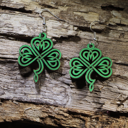 Hand-painted wooden Celtic knot shamrock dangle earrings featuring an intricate four-leaf shamrock inspired by traditional Celtic knotwork. Lightweight wooden earrings with hypoallergenic .925 sterling silver hooks, perfect for St. Patrick&