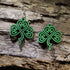 Hand-painted wooden Celtic knot shamrock dangle earrings featuring an intricate four-leaf shamrock inspired by traditional Celtic knotwork. Lightweight wooden earrings with hypoallergenic .925 sterling silver hooks, perfect for St. Patrick&