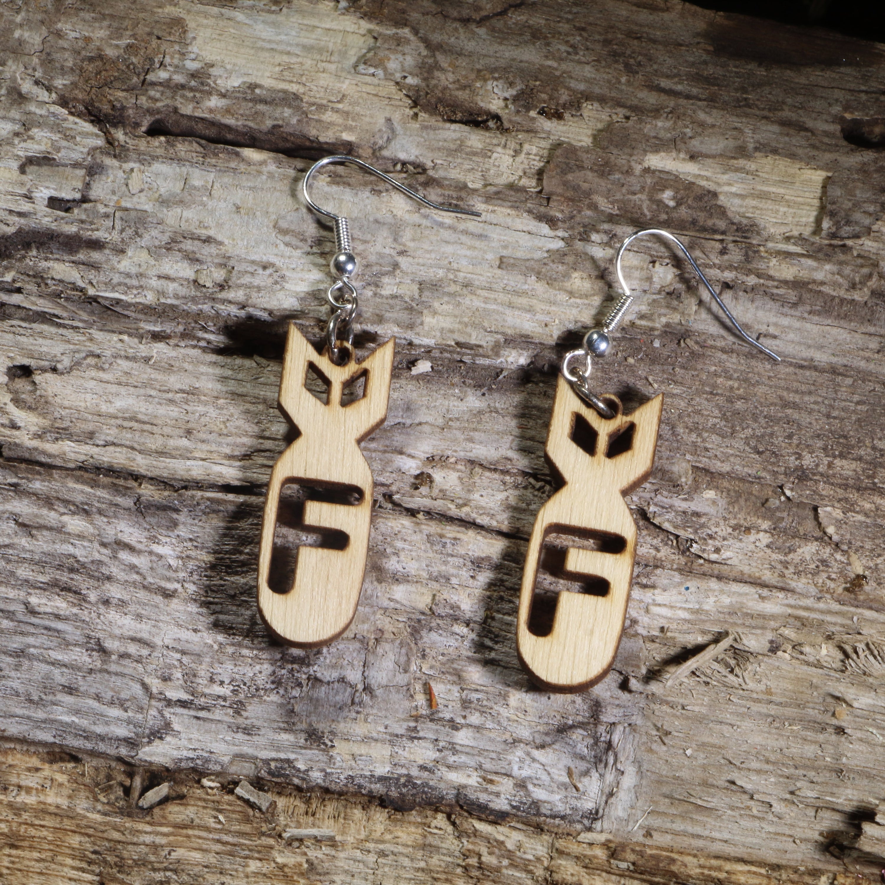  Hand-painted wooden F-bomb dangle earrings featuring a stylized cartoon bomb with a bold cutout letter "F" on hypoallergenic .925 sterling silver hooks. Lightweight novelty earrings perfect for sarcastic humor, edgy fashion, gag gifts, and fans of witty statement jewelry.