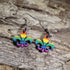 Hand-painted wooden LGBTQ+ Pride fleur-de-lis dangle earrings featuring the iconic fleur-de-lis symbol in rainbow pride colors on hypoallergenic .925 sterling silver hooks. Lightweight New Orleans–inspired jewelry celebrating LGBTQ+ pride, equality, and Louisiana culture.