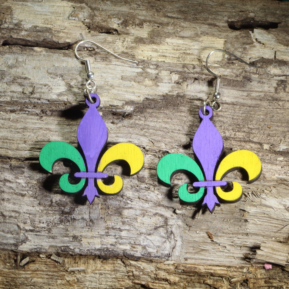 Hand-painted wooden Large  Mardi Gras fleur-de-lis dangle earrings featuring the iconic fleur-de-lis in traditional purple, green, and gold on hypoallergenic .925 sterling silver hooks. Lightweight New Orleans jewelry for Mardi Gras celebrations, Louisiana culture, Carnival festivities, festival outfits, and fleur-de-lis enthusiasts.