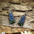 Hand-painted wooden Texas Bluebonnet dangle earrings featuring the iconic blue state flower of Texas with vibrant floral details. Crafted from lightweight wood with hypoallergenic .925 sterling silver hooks, these artisan earrings are perfect for Texas pride, wildflower lovers, spring festivals, Bluebonnet season, nature enthusiasts, travel souvenirs, and anyone who loves colorful botanical jewelry inspired by the Lone Star State.