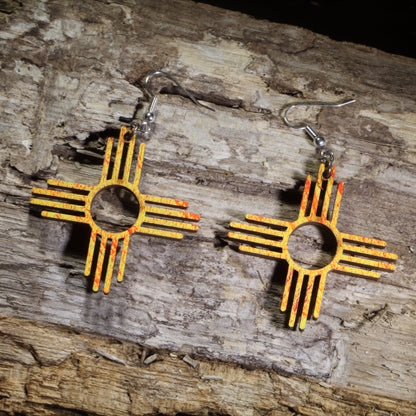 Hand-painted wooden Zia Sun symbol dangle earrings inspired by the New Mexico state symbol in vibrant orange and yellow on hypoallergenic .925 sterling silver hooks. Lightweight Southwestern jewelry perfect for New Mexico lovers, desert enthusiasts, and Southwest style.