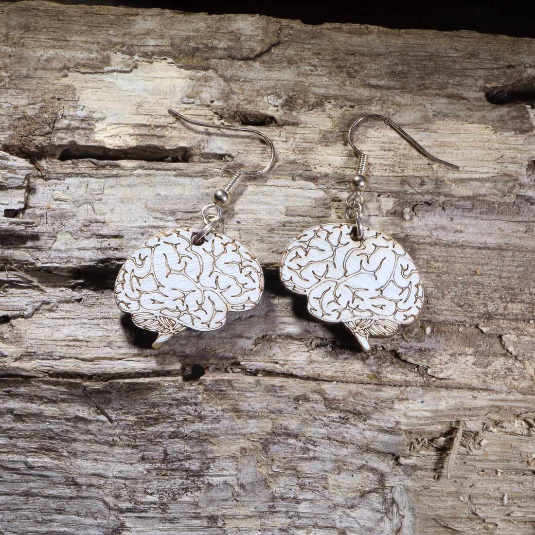 Hand-painted wooden brain dangle earrings featuring an anatomically inspired brain design on lightweight wood with hypoallergenic .925 sterling silver hooks. Perfect for neurologists, neuroscientists, psychologists, medical students, science teachers, healthcare professionals, and unique anatomy jewelry lovers.