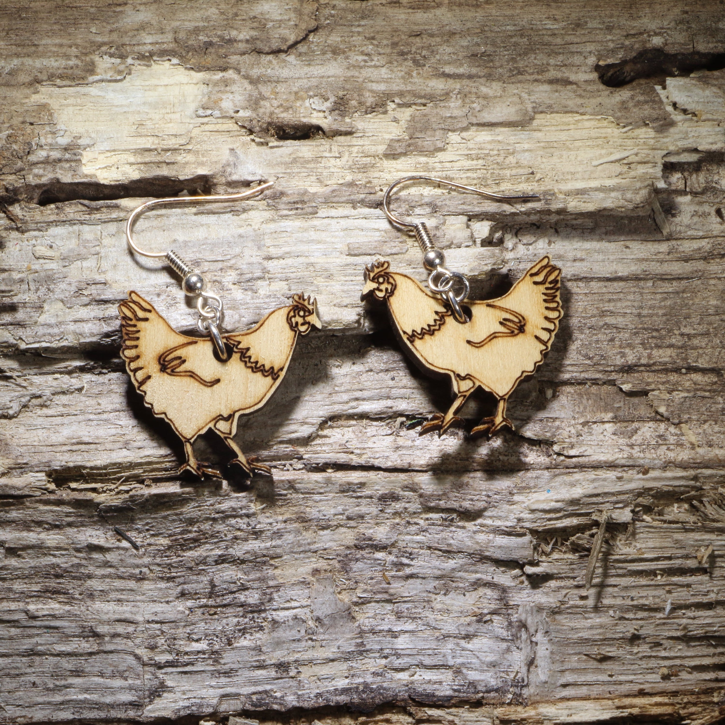 Hand-painted wooden chicken dangle earrings featuring detailed hen silhouettes on lightweight wood with hypoallergenic .925 sterling silver hooks. Perfect for chicken lovers, backyard chicken keepers, poultry farmers, homesteaders, farm animal enthusiasts, and unique country-inspired jewelry.