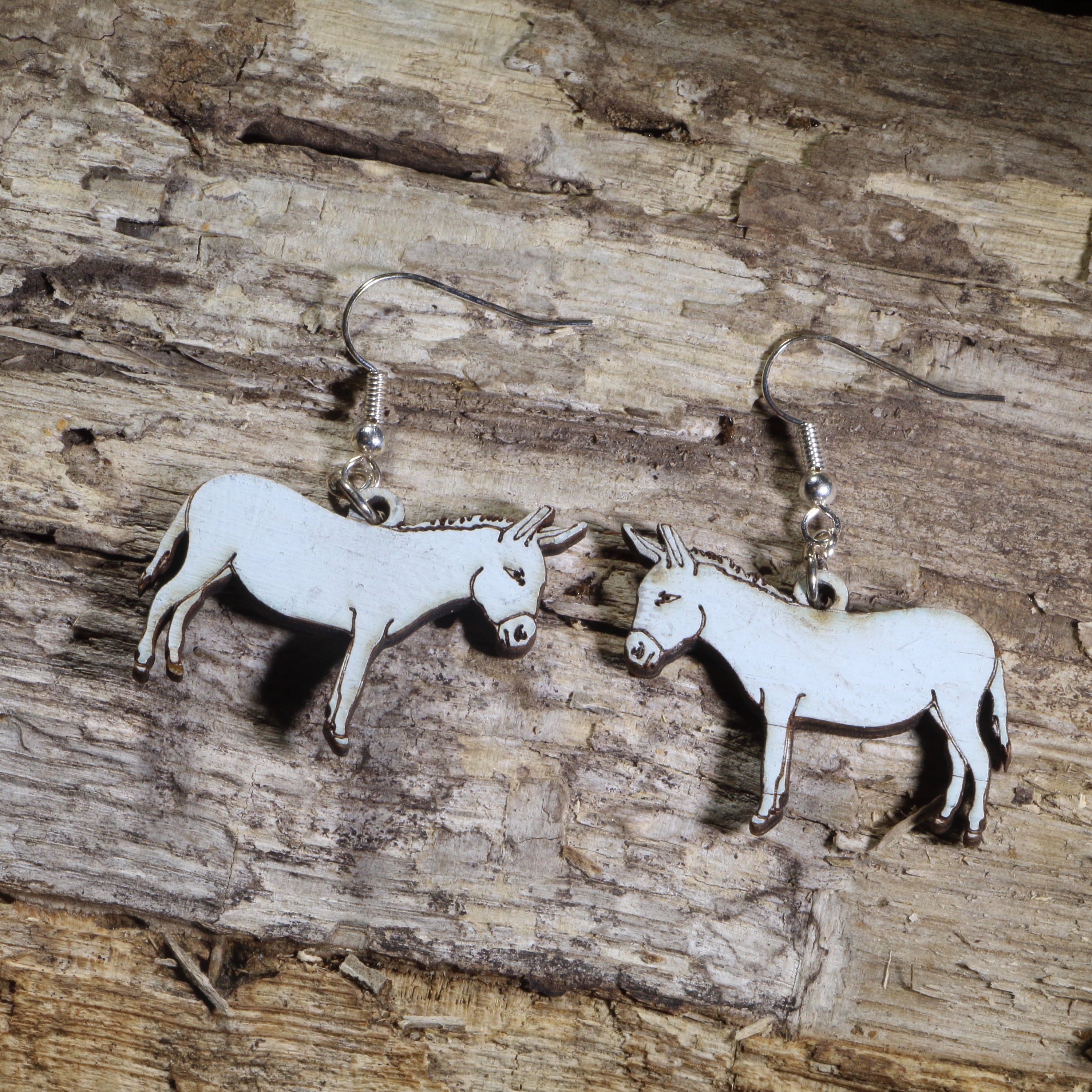 Hand-painted wooden donkey dangle earrings featuring detailed donkey artwork on hypoallergenic .925 sterling silver hooks. Lightweight farm animal jewelry for donkey lovers, farmers, ranchers, equestrians, animal lovers, and anyone who enjoys unique country-inspired accessories.
