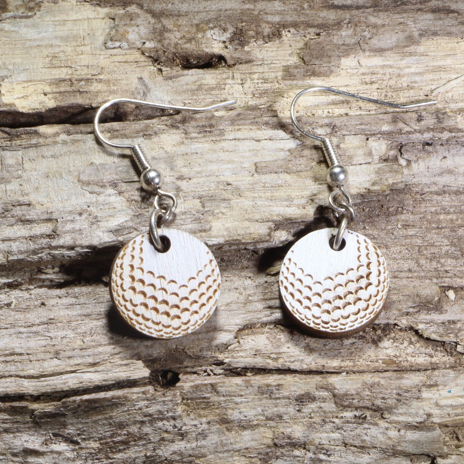 Hand-painted wooden golf ball dangle earrings featuring realistic engraved dimples on hypoallergenic .925 sterling silver hooks. Lightweight golf jewelry for golfers, golf coaches, country club members, tournament gifts, and golf enthusiasts.