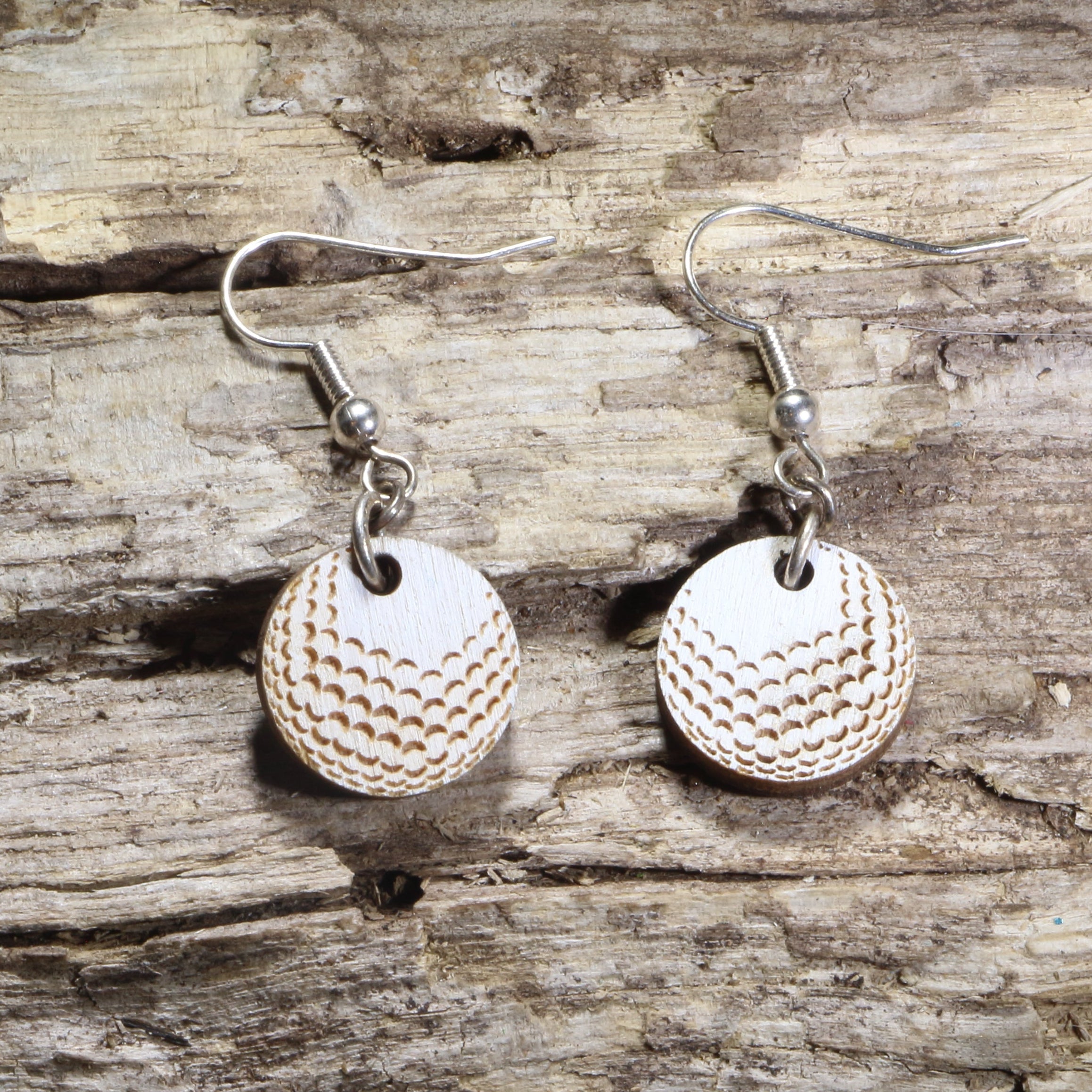 Hand-painted wooden golf ball dangle earrings featuring realistic engraved dimples on hypoallergenic .925 sterling silver hooks. Lightweight golf jewelry for golfers, golf coaches, country club members, tournament gifts, and golf enthusiasts.