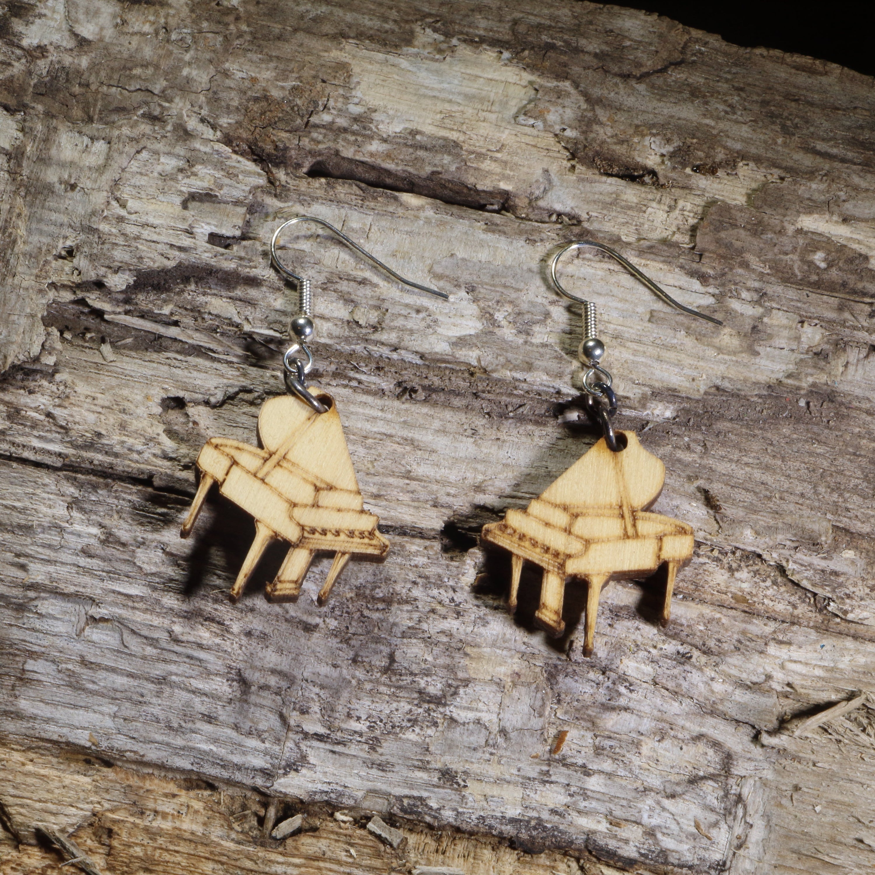 Hand-painted wooden grand piano dangle earrings featuring detailed baby grand pianos on hypoallergenic .925 sterling silver hooks. Lightweight music-inspired jewelry for pianists, piano teachers, musicians, music students, and classical music lovers.