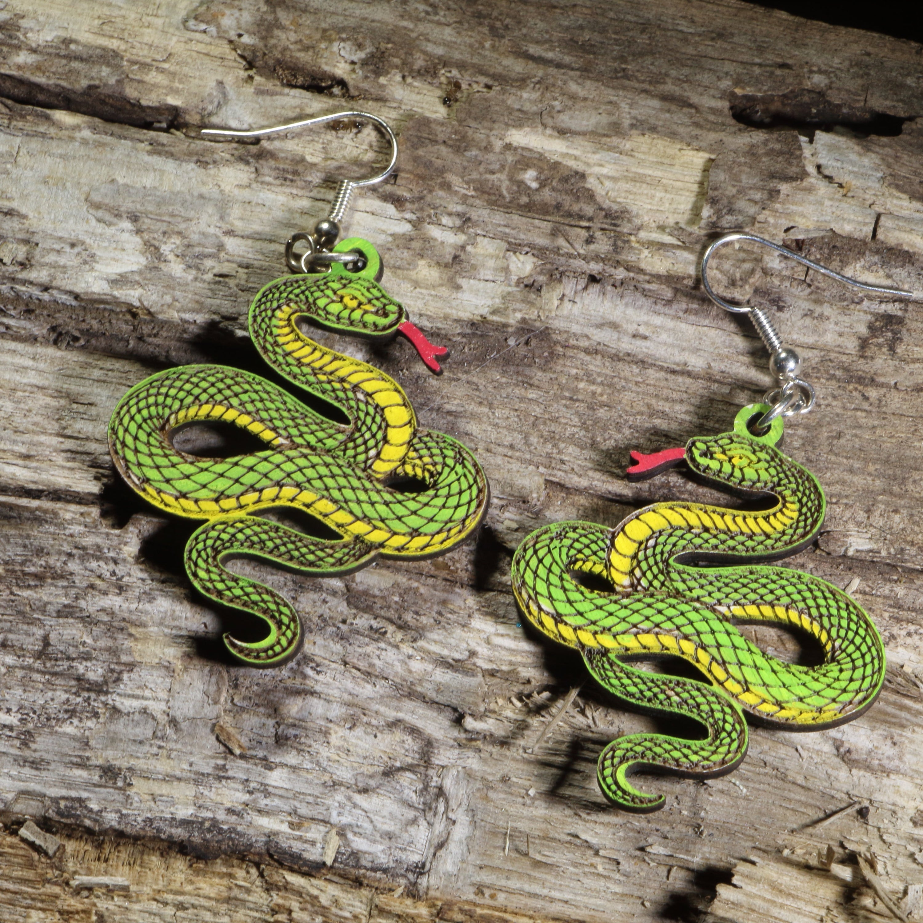 Hand-painted wooden green snake dangle earrings featuring a coiled green serpent design on hypoallergenic .925 sterling silver hooks. Lightweight reptile nature jewelry for snake lovers, herpetologists, wildlife enthusiasts, and anyone who appreciates unique animal-inspired accessories.