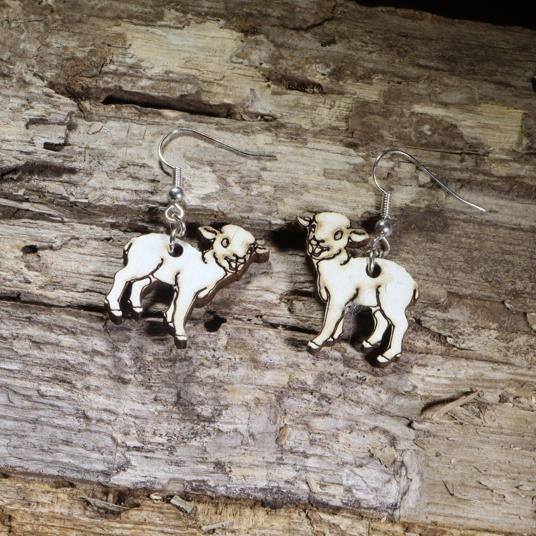 Hand-painted wooden lamb dangle earrings on hypoallergenic .925 sterling silver hooks. Lightweight farm animal jewelry for sheep lovers, shepherds, farmers, Easter celebrations, and country life enthusiasts.