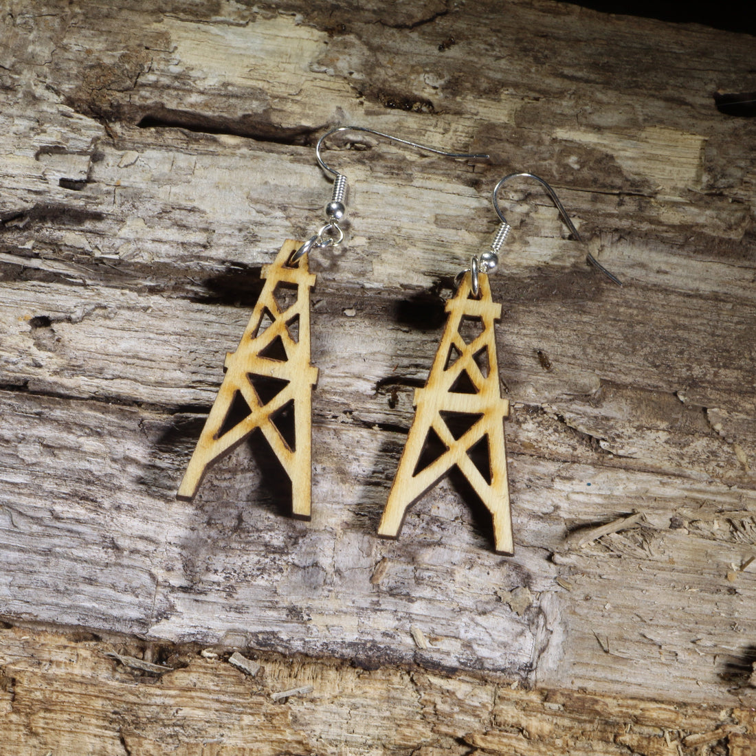 Hand-painted wooden oil derrick dangle earrings on hypoallergenic .925 sterling silver hooks. Lightweight oilfield jewelry for petroleum engineers, roughnecks, drilling crews, oil and gas professionals, and energy industry enthusiasts.