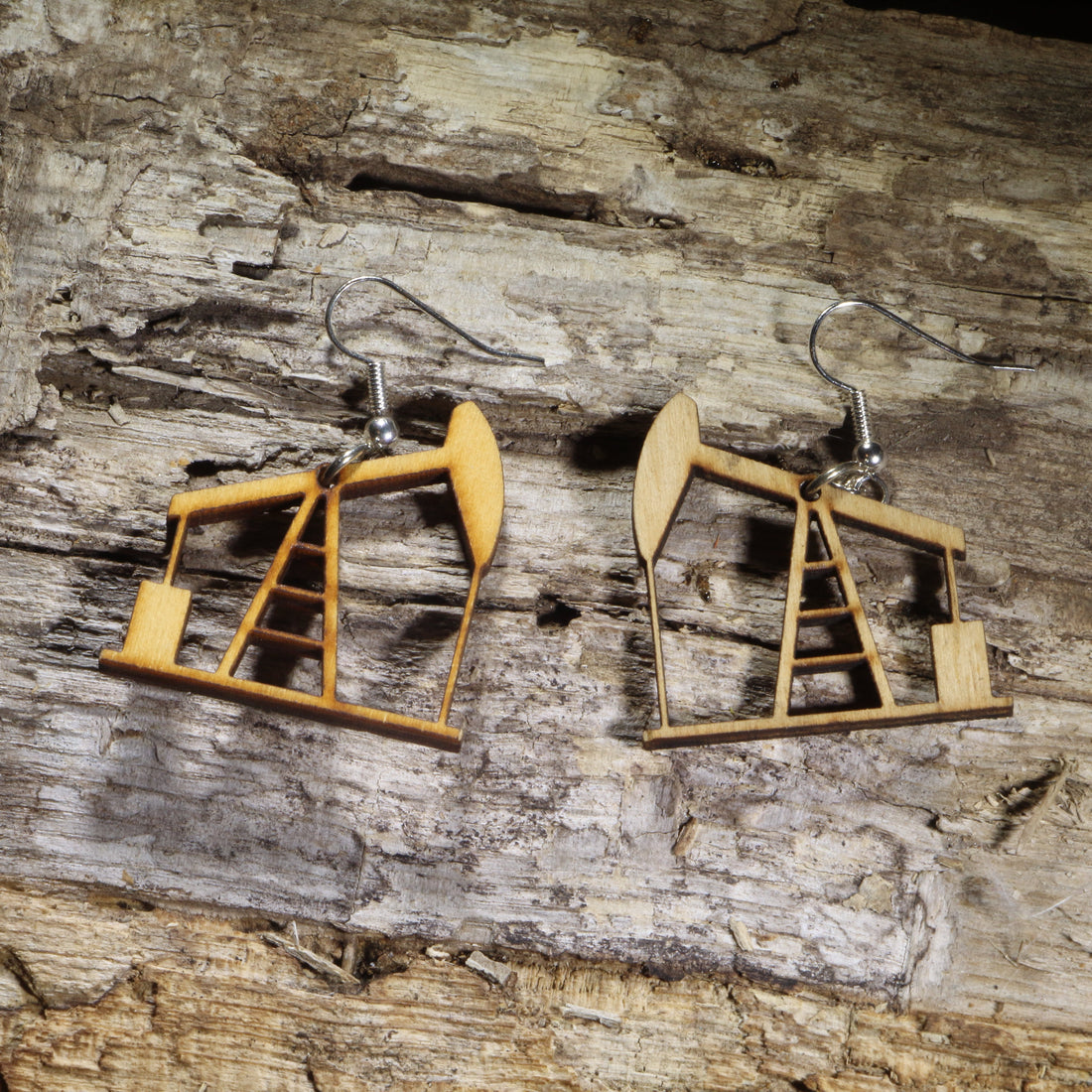 Hand-painted wooden oil pumpjack dangle earrings on hypoallergenic .925 sterling silver hooks. Lightweight oilfield jewelry for petroleum engineers, roughnecks, oil and gas workers, energy professionals, and industry enthusiasts.