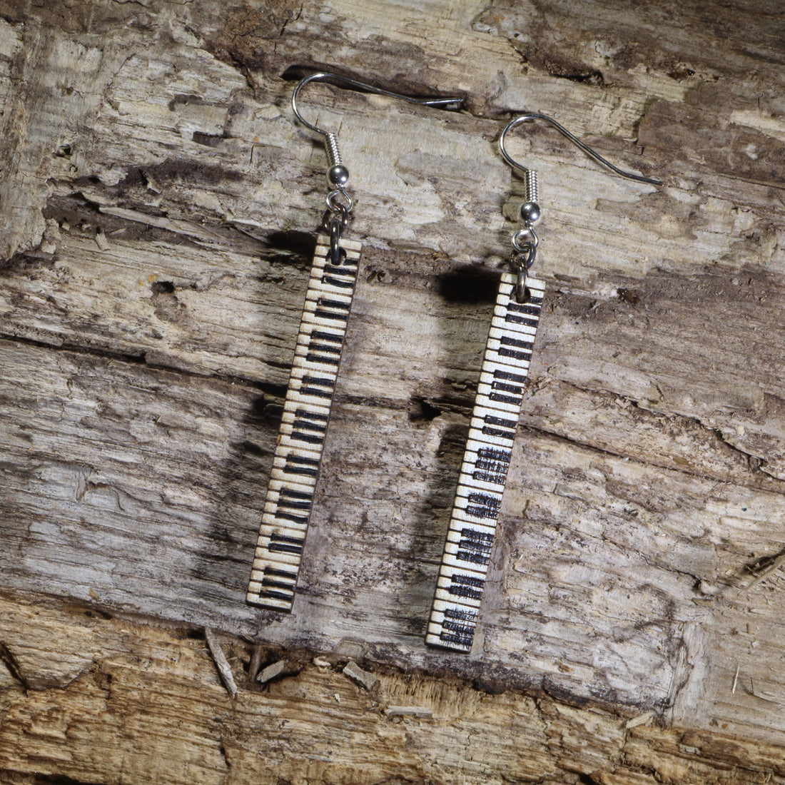 Hand-painted wooden piano keyboard bar dangle earrings featuring long vertical black and white piano keys on hypoallergenic .925 sterling silver hooks. Lightweight music jewelry perfect for pianists, piano teachers, music students, musicians, and classical music lovers.