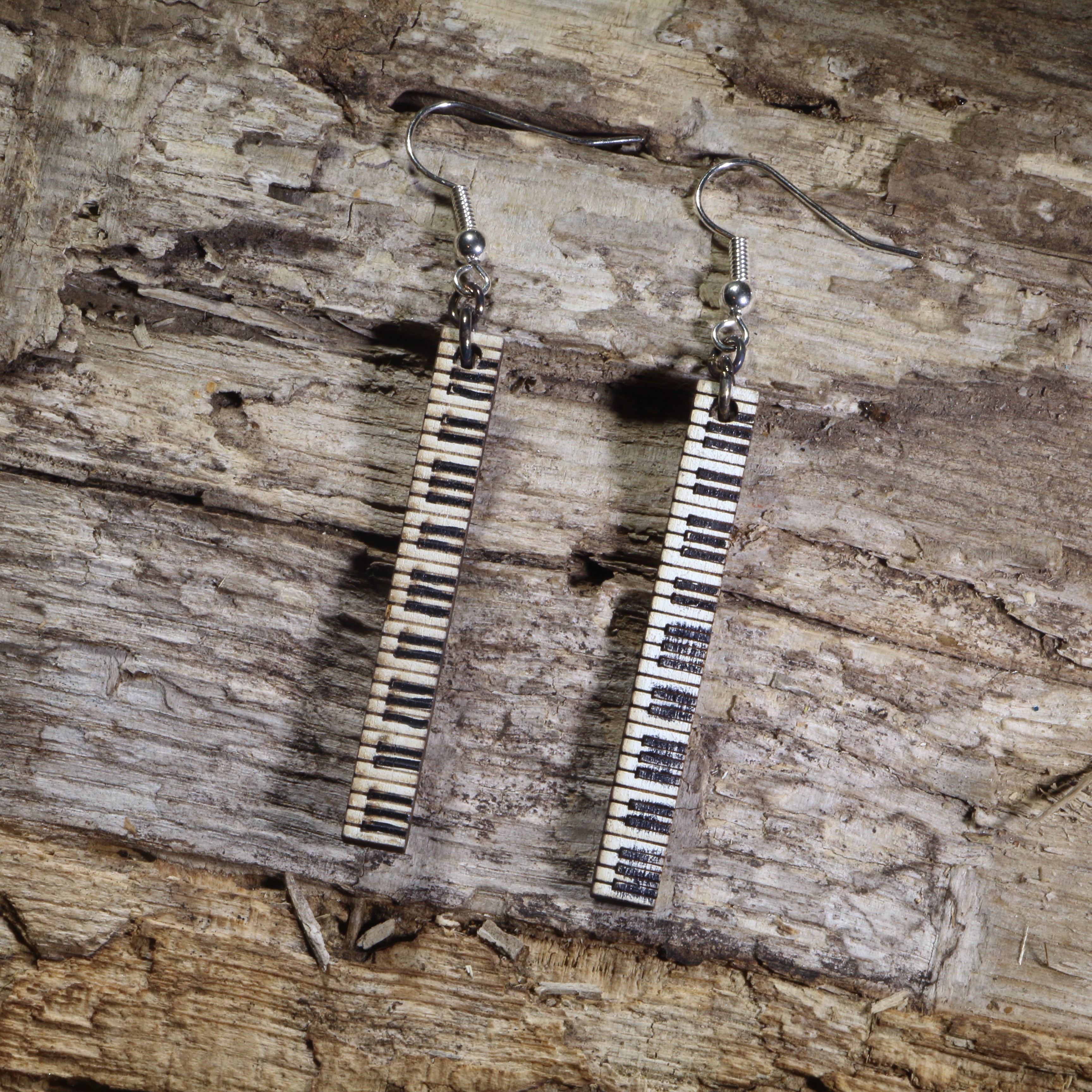 Hand-painted wooden piano keyboard bar dangle earrings featuring long vertical black and white piano keys on hypoallergenic .925 sterling silver hooks. Lightweight music jewelry perfect for pianists, piano teachers, music students, musicians, and classical music lovers.