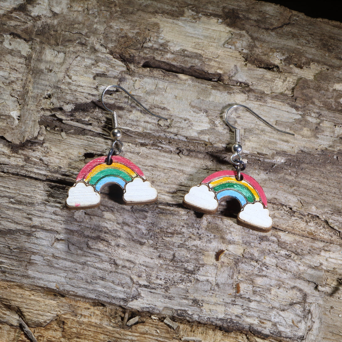 Hand-painted wooden rainbow dangle earrings on hypoallergenic .925 sterling silver hooks. Lightweight colorful Pride jewelry celebrating LGBTQ+ pride, equality, inclusion, self-expression, and joyful everyday style.