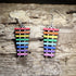 Hand-painted wooden rainbow xylophone dangle earrings featuring colorful xylophone bars on hypoallergenic .925 sterling silver hooks. Lightweight music-inspired jewelry for musicians, music teachers, percussionists, band members, orchestra students, and Pride supporters.