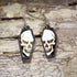 Hand-painted wooden skull in coffin dangle earrings featuring a detailed gothic skull framed inside a black coffin on hypoallergenic .925 sterling silver hooks. Lightweight gothic jewelry for Halloween, spooky style, horror fans, alternative fashion, and skull lovers.
