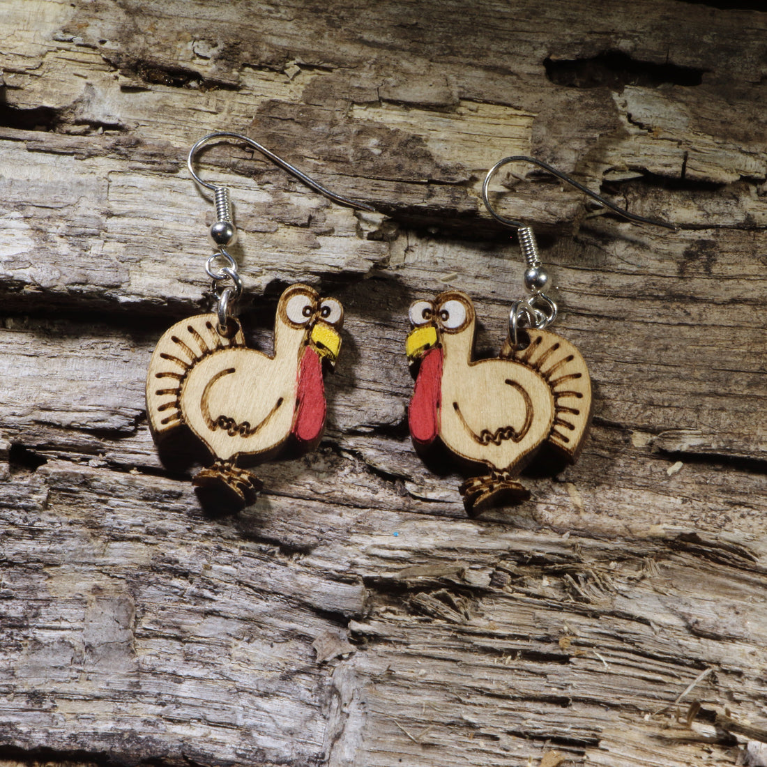 Hand-painted wooden turkey dangle earrings featuring a playful Thanksgiving turkey design. Lightweight fall-inspired earrings with hypoallergenic .925 sterling silver hooks, perfect for Thanksgiving celebrations, autumn festivals, turkey lovers, teachers, and anyone who enjoys festive seasonal jewelry.