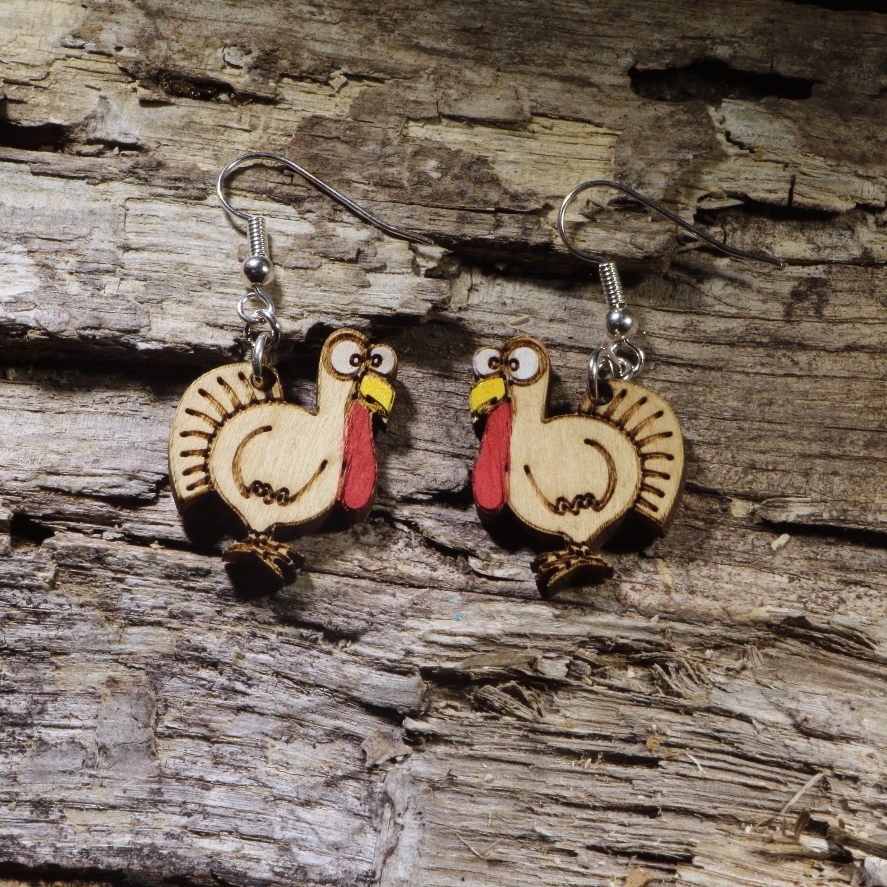 Hand-painted wooden turkey dangle earrings featuring a playful Thanksgiving turkey design. Lightweight fall-inspired earrings with hypoallergenic .925 sterling silver hooks, perfect for Thanksgiving celebrations, autumn festivals, turkey lovers, teachers, and anyone who enjoys festive seasonal jewelry.