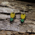 Hand-painted wooden upside-down pineapple dangle earrings featuring the iconic upside-down pineapple symbol in vibrant yellow and green. Lightweight wooden earrings with hypoallergenic .925 sterling silver hooks, perfect for tropical style, cruise vacations, beach lovers, and playful conversation-starting accessories.