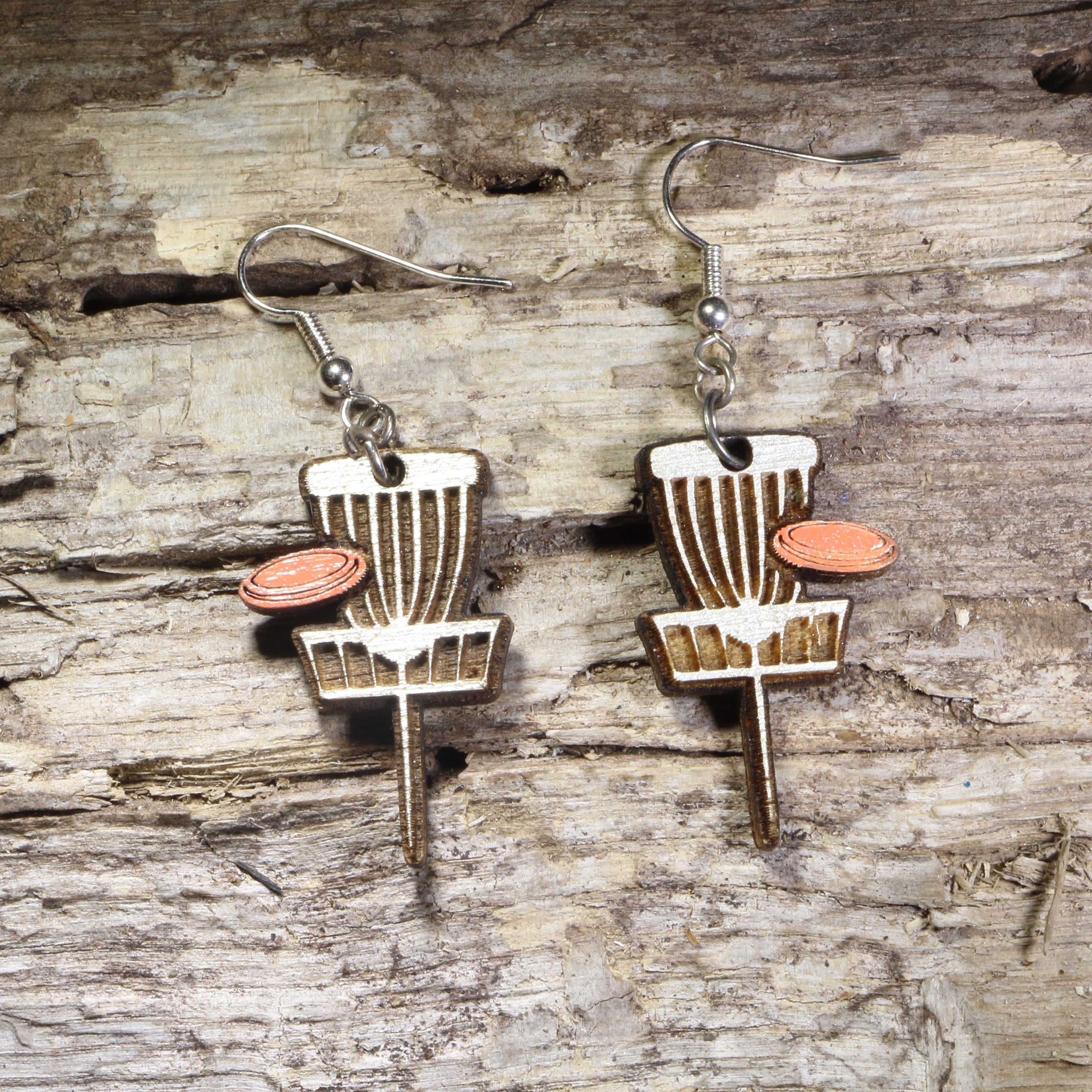 Handcrafted Disc Golf Basket wooden dangle earrings featuring a disc golf target basket with an orange flying disc. Lightweight laser-cut wooden earrings with hypoallergenic .925 sterling silver hooks, perfect for disc golf players, frisbee golf enthusiasts,  outdoor sports lovers, and unique sports jewelry.