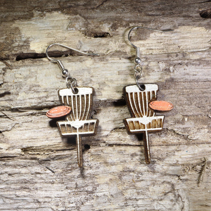 Handcrafted Disc Golf Basket wooden dangle earrings featuring a disc golf target basket with an orange flying disc. Lightweight laser-cut wooden earrings with hypoallergenic .925 sterling silver hooks, perfect for disc golf players, frisbee golf enthusiasts,  outdoor sports lovers, and unique sports jewelry.