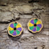 Handcrafted King Cake wooden dangle earrings featuring a colorful Mardi Gras king cake slice design in traditional purple, green, and gold. Lightweight laser-cut wooden earrings with hypoallergenic .925 sterling silver hooks, perfect for Mardi Gras celebrations, Fat Tuesday, New Orleans festivals, Louisiana pride, bakeries, and handmade festive jewelry.
