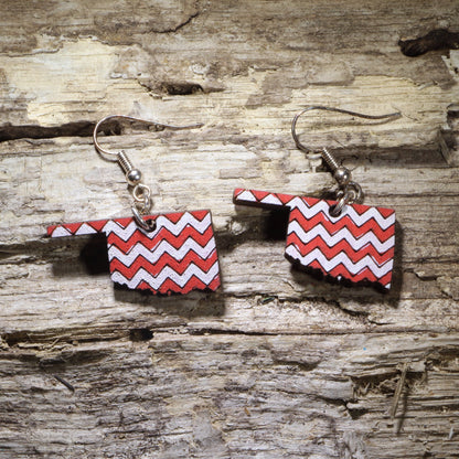 Handcrafted Oklahoma-shaped wooden dangle earrings featuring a bold red and white chevron pattern. Lightweight Oklahoma state earrings with hypoallergenic .925 sterling silver hooks, perfect for Oklahoma pride, southern style, western fashion, college game day outfits, and unique handmade statement jewelry.