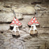 Handcrafted fairy mushroom house wooden dangle earrings featuring whimsical red spotted mushroom cottages with tiny windows and doors. Lightweight hand-painted wooden earrings with hypoallergenic .925 sterling silver hooks, perfect for cottagecore fashion, fairy garden lovers, fantasy enthusiasts, woodland décor fans, whimsical gifts, and enchanted forest accessories.