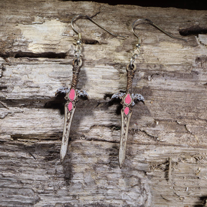Handcrafted fantasy sword wooden dangle earrings featuring an ornate medieval blade with pink gemstone accents and detailed crossguard. Lightweight laser-cut wooden earrings with hypoallergenic .925 sterling silver hooks, perfect for fantasy fans, RPG gamers, cosplay, medieval enthusiasts, Renaissance festival outfits, and sword collectors.