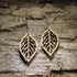 Handcrafted skeleton leaf wooden dangle earrings featuring an intricate laser-cut leaf vein design in natural Baltic birch wood. Lightweight wooden earrings with hypoallergenic .925 sterling silver hooks, perfect for nature lovers, botanical jewelry fans, woodland style, fall fashion, eco-friendly accessories, and handmade leaf earrings.