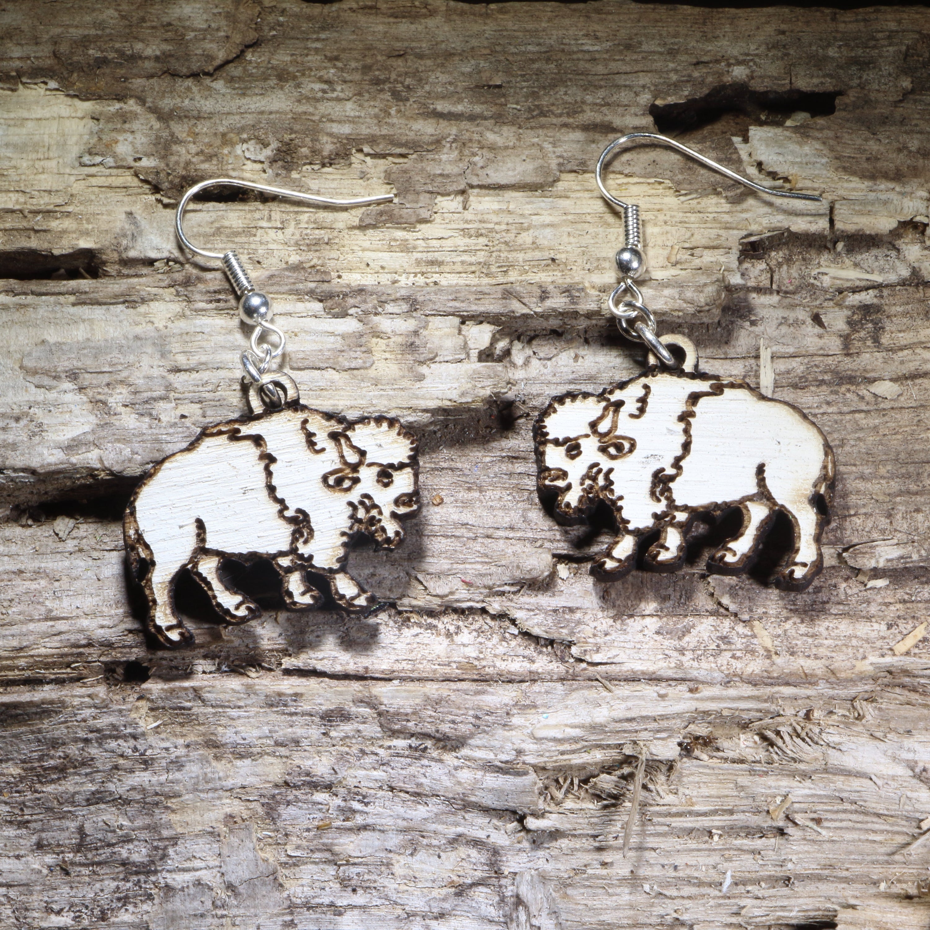 Handcrafted white buffalo wooden dangle earrings featuring a detailed American bison silhouette with engraved accents. Lightweight laser-cut wooden earrings with hypoallergenic .925 sterling silver hooks, perfect for wildlife lovers, Western style, National Park enthusiasts, buffalo fans, and handmade nature-inspired jewelry.