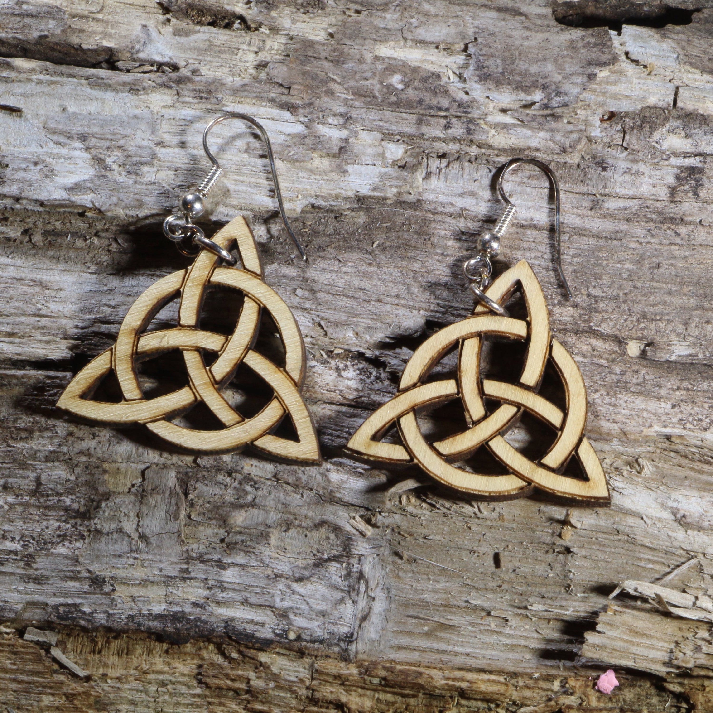 Handcrafted wooden Celtic Trinity Knot dangle earrings featuring the timeless Triquetra symbol in a natural wood finish with precision laser-cut detailing. These lightweight Celtic earrings are finished with hypoallergenic .925 sterling silver hooks, making them a meaningful accessory for Celtic heritage, Irish traditions, pagan and spiritual practices, Renaissance fairs, and everyday wear.